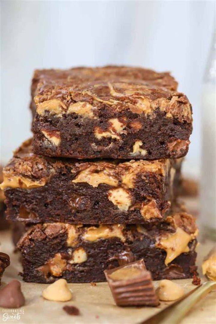 Stack of three peanut brownies on a plate.